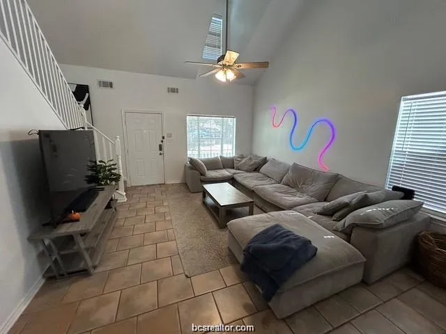 a living room with furniture and a flat screen tv