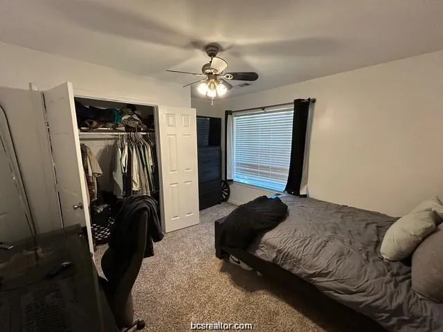 a bedroom with a bed and a walk in closet