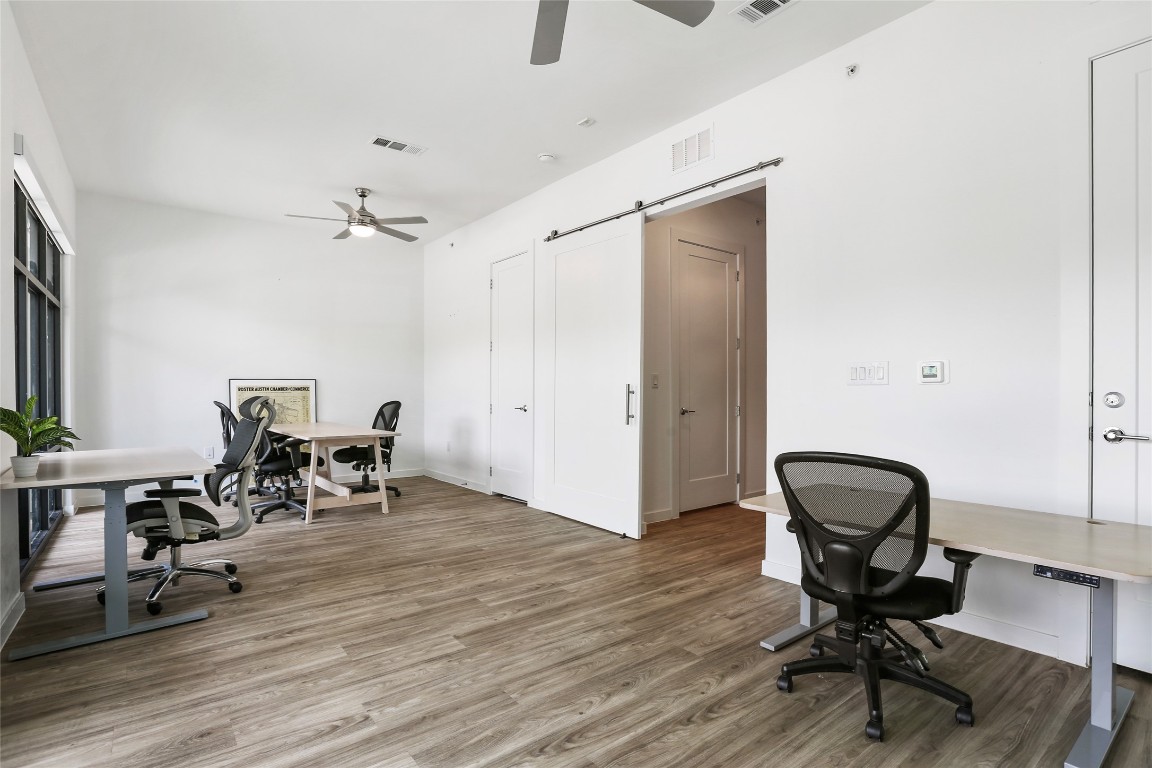 a view of a workspace with furniture and lounge chair