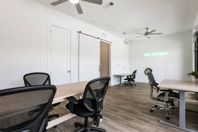 a living room with furniture and large windows