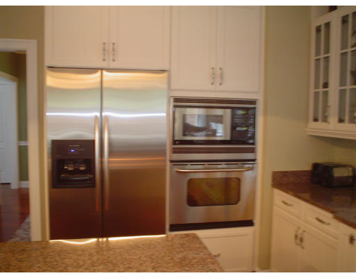 71 Stone School Road Sutton, MA 01590 - Photo 11 of 30 a kitchen with a refrigerator and cabinets