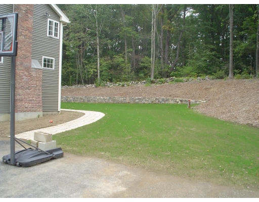 71 Stone School Road Sutton, MA 01590 - Photo 3 of 30 a view of a backyard with a fountain