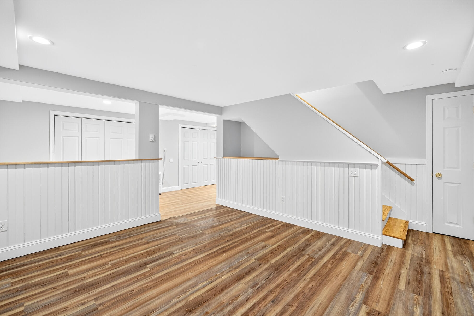 33 Captain William Arthur Road Brewster, MA 02631 - Photo 21 of 40 a view of an empty room with wooden floor and stairs