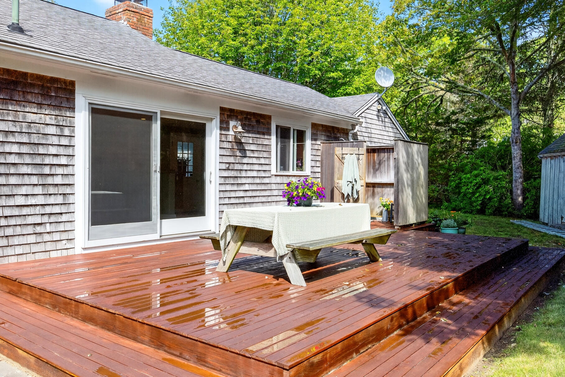 33 Captain William Arthur Road Brewster, MA 02631 - Photo 30 of 40 a view of a patio with table and chairs next to a yard