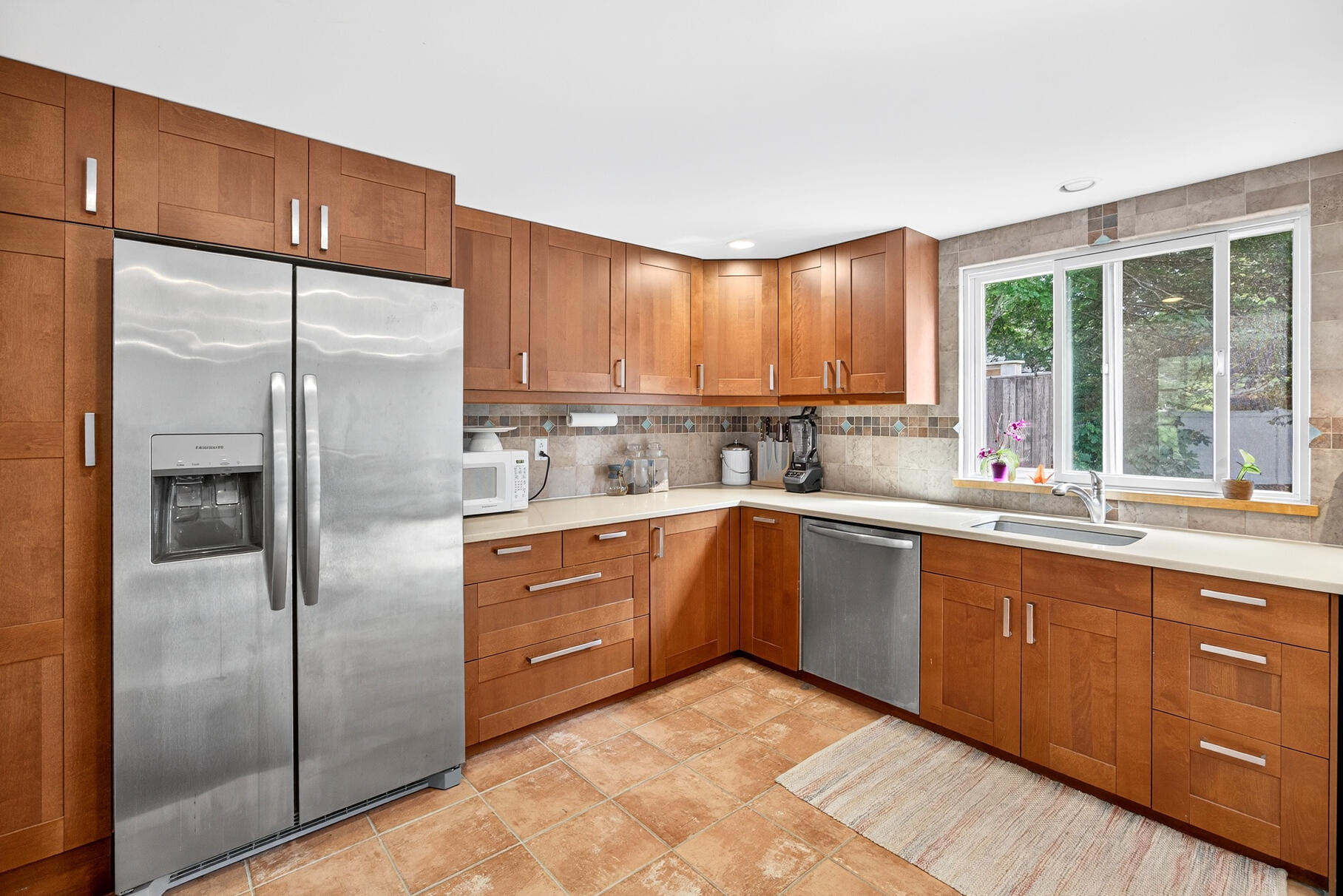 33 Captain William Arthur Road Brewster, MA 02631 - Photo 5 of 40 a kitchen with stainless steel appliances granite countertop a refrigerator sink and cabinets