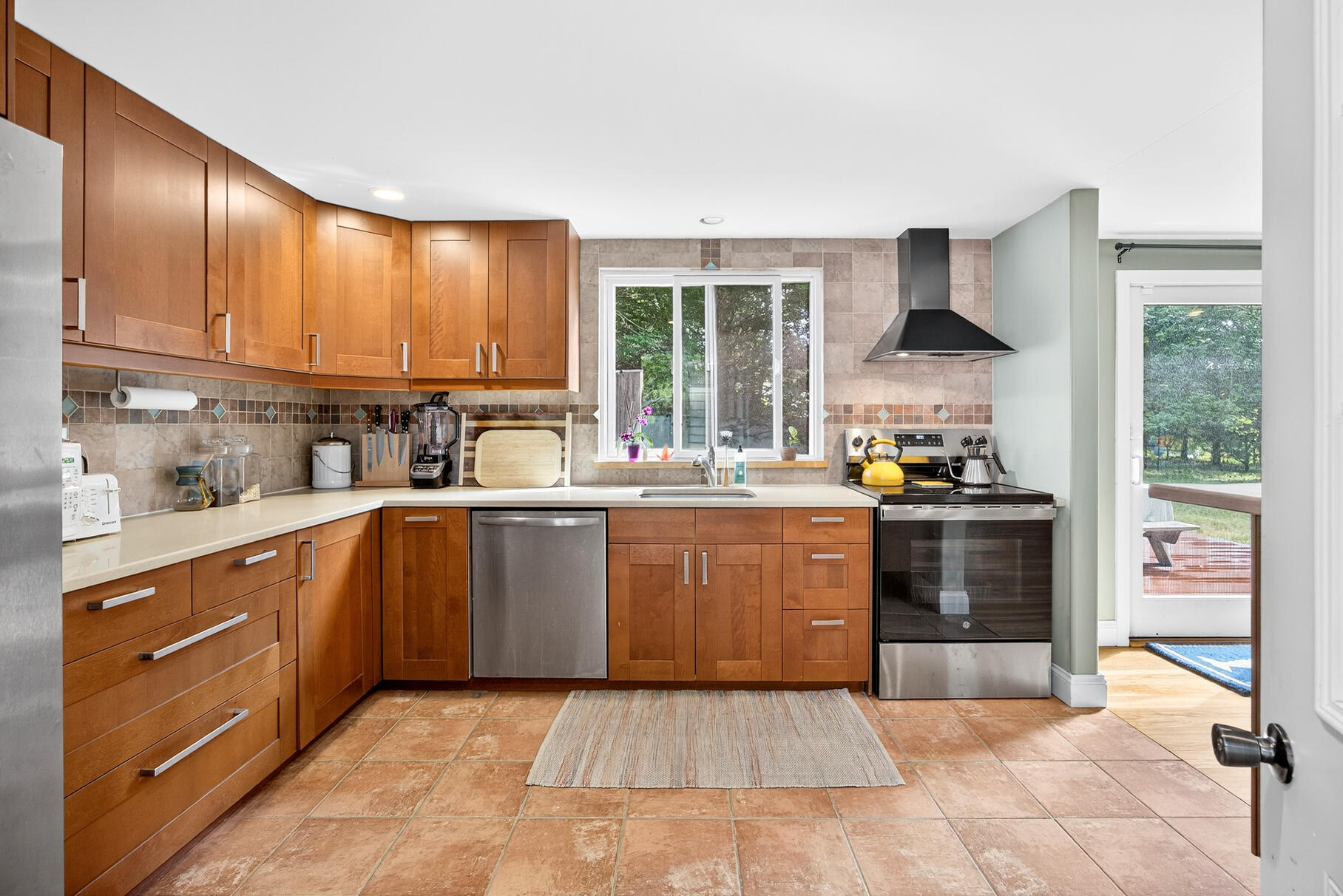 33 Captain William Arthur Road Brewster, MA 02631 - Photo 6 of 40 a kitchen with stainless steel appliances granite countertop a stove a sink and a refrigerator