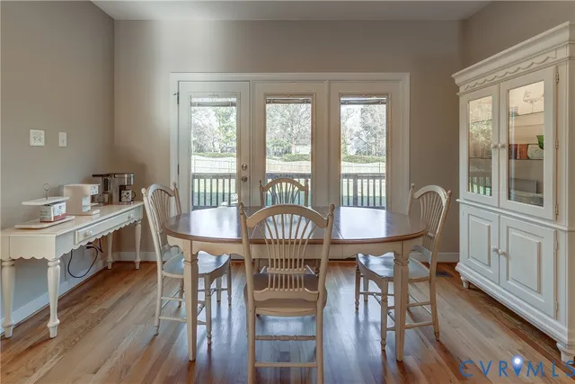 a view of a a dining room with furniture window and wooden floor