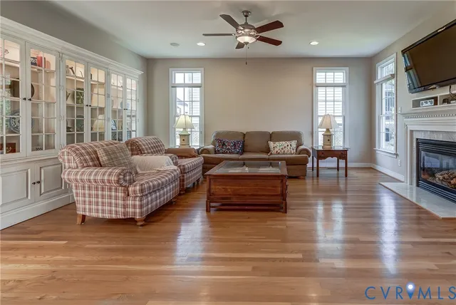 a living room with furniture fireplace and flat screen tv