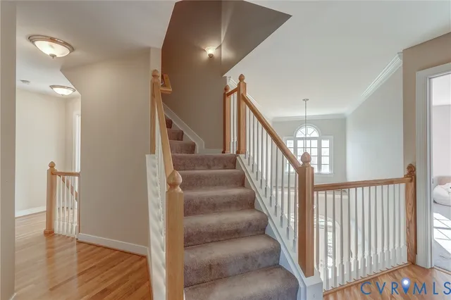 a view of a hallway with wooden floor and entryway