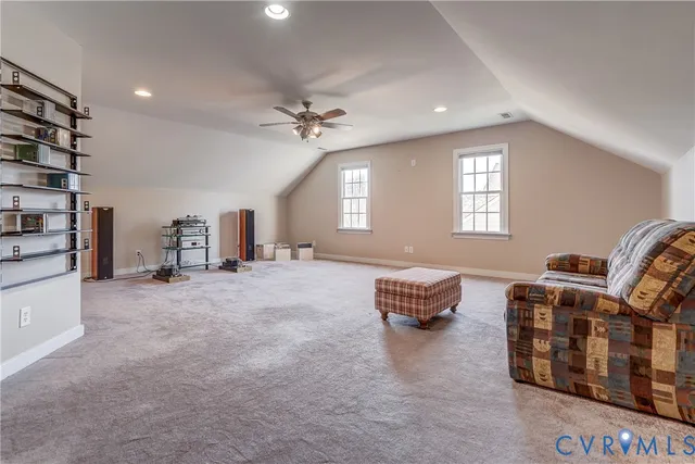 a spacious bedroom with a bed a chandelier and a window