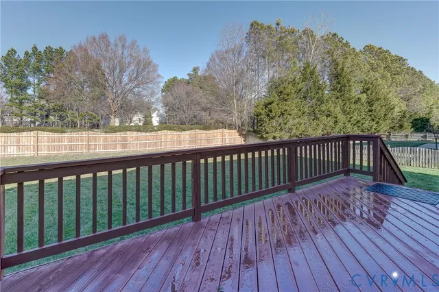 a view of balcony with wooden floor and fence