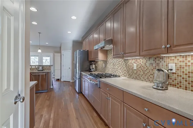 a kitchen with sink cabinets and stainless steel appliances