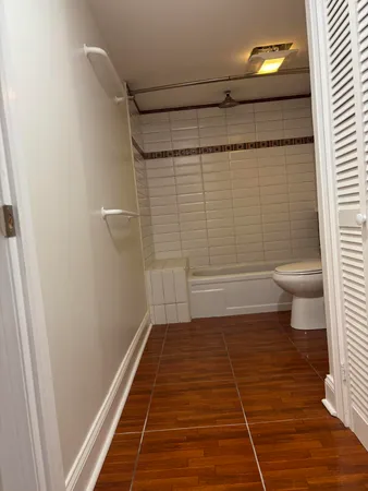 a bathroom with a toilet and a shower