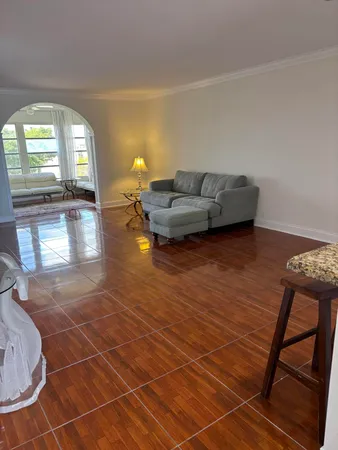 a living room with furniture and a floor to ceiling window