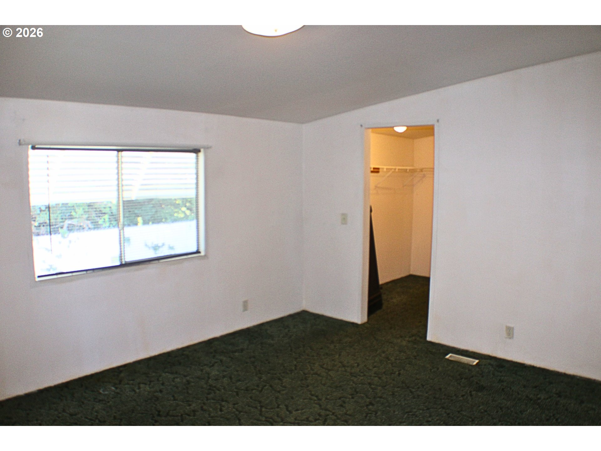 130 Stephanie Court Winston, OR 97496 - Photo 11 of 22 a view of an empty room with wooden floor and a window