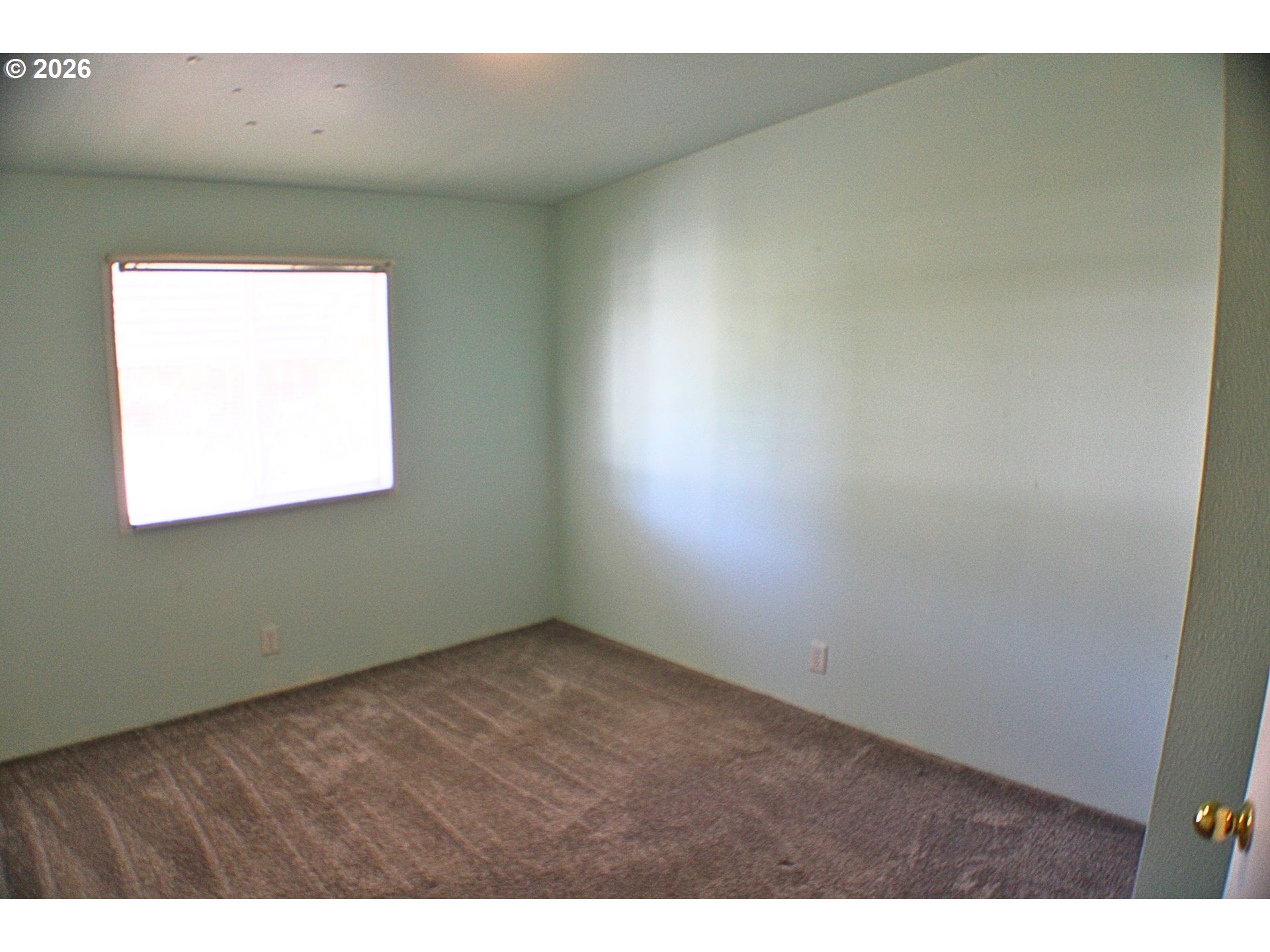 130 Stephanie Court Winston, OR 97496 - Photo 8 of 22 a view of an empty room with a window