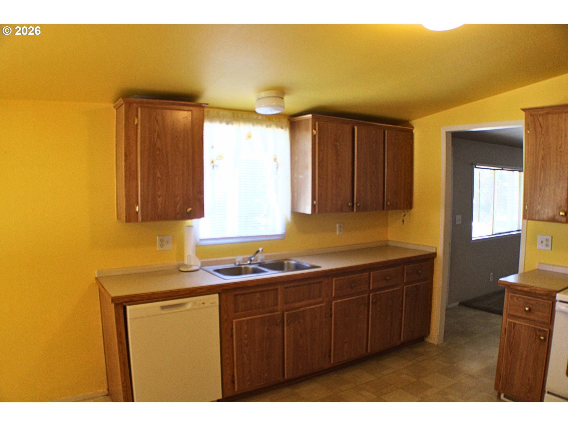 130 Stephanie Court Winston, OR 97496 - Photo 10 of 22 a kitchen with a sink a window and cabinets