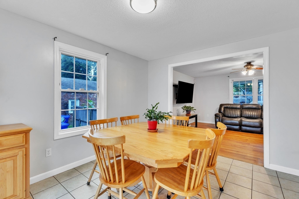 44 Border Street Springfield, MA 01104 - Photo 11 of 37 a view of a dining room with furniture and a flat screen tv