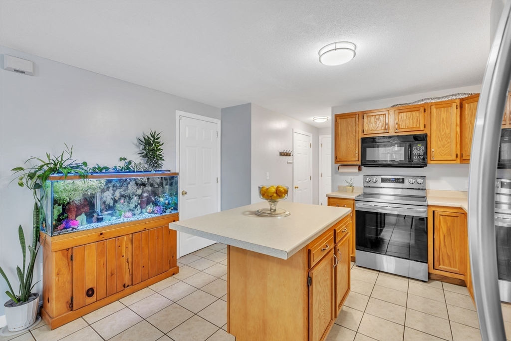 44 Border Street Springfield, MA 01104 - Photo 16 of 37 a kitchen that has a sink and a stove in it