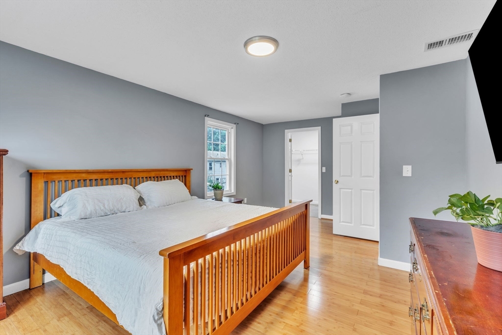 44 Border Street Springfield, MA 01104 - Photo 18 of 37 a bedroom with a bed and a potted plant