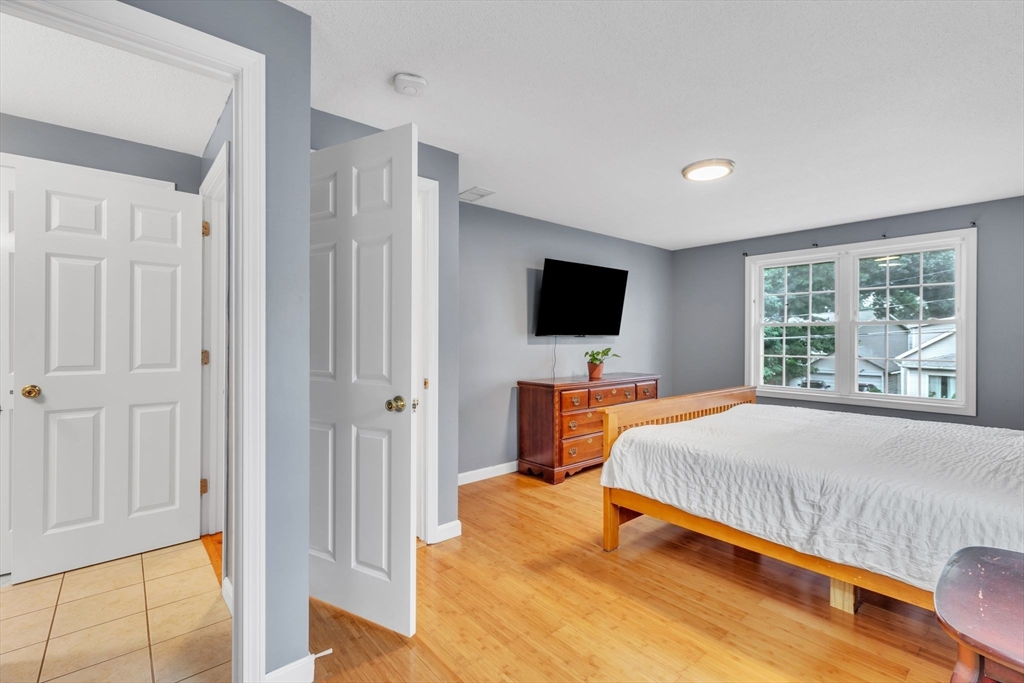 44 Border Street Springfield, MA 01104 - Photo 21 of 37 a bedroom with a bed and a flat screen tv