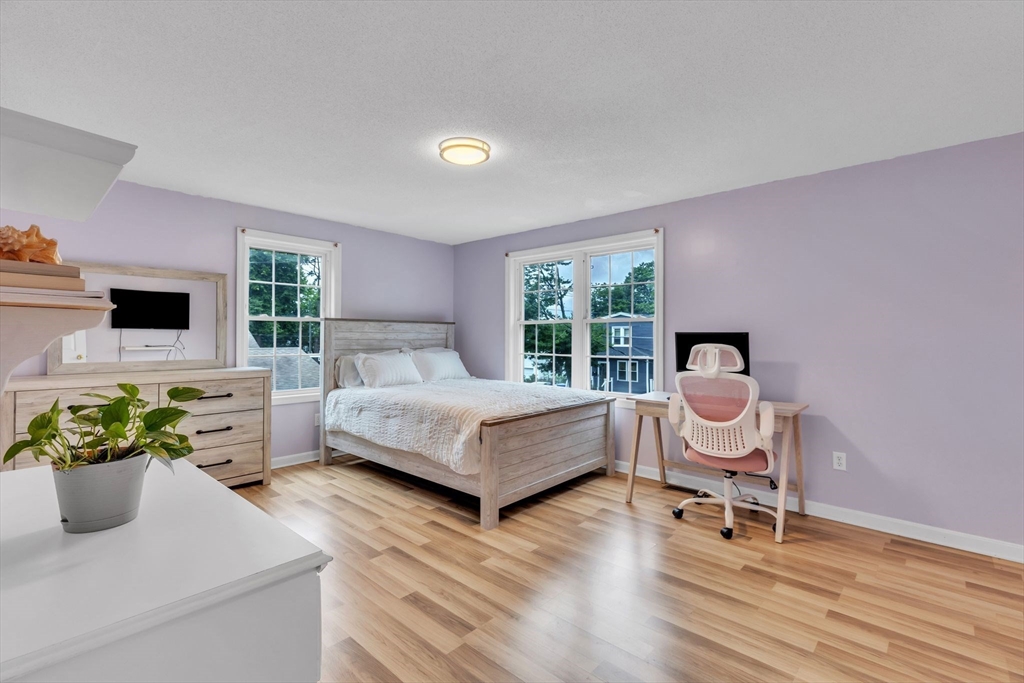 44 Border Street Springfield, MA 01104 - Photo 22 of 37 a bedroom with a bed and a chair