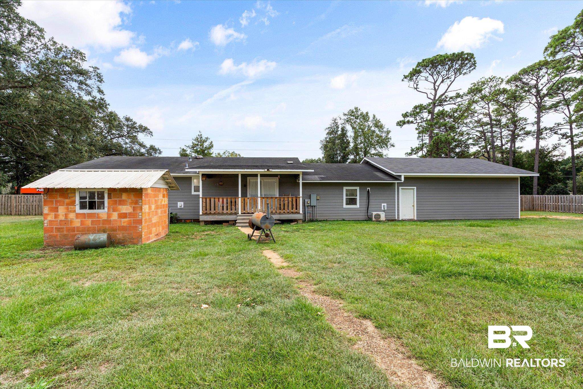 10391 County Road 64 Daphne, AL 36526 - Photo 18 of 23 Rear view of house with a yard, a deck, and a shed