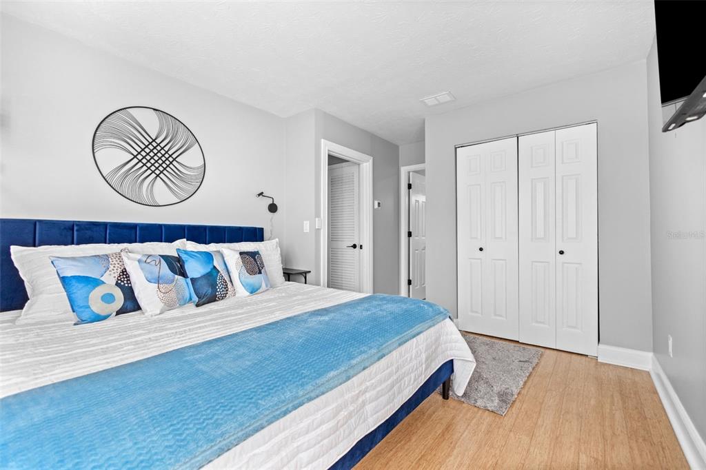 3443 Clark Road, Unit 242 Sarasota, FL 34231 - Photo 13 of 21 a bedroom with a large bed and a tv