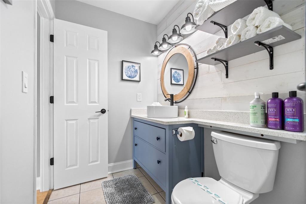 3443 Clark Road, Unit 242 Sarasota, FL 34231 - Photo 15 of 21 a bathroom with a toilet a sink and a mirror