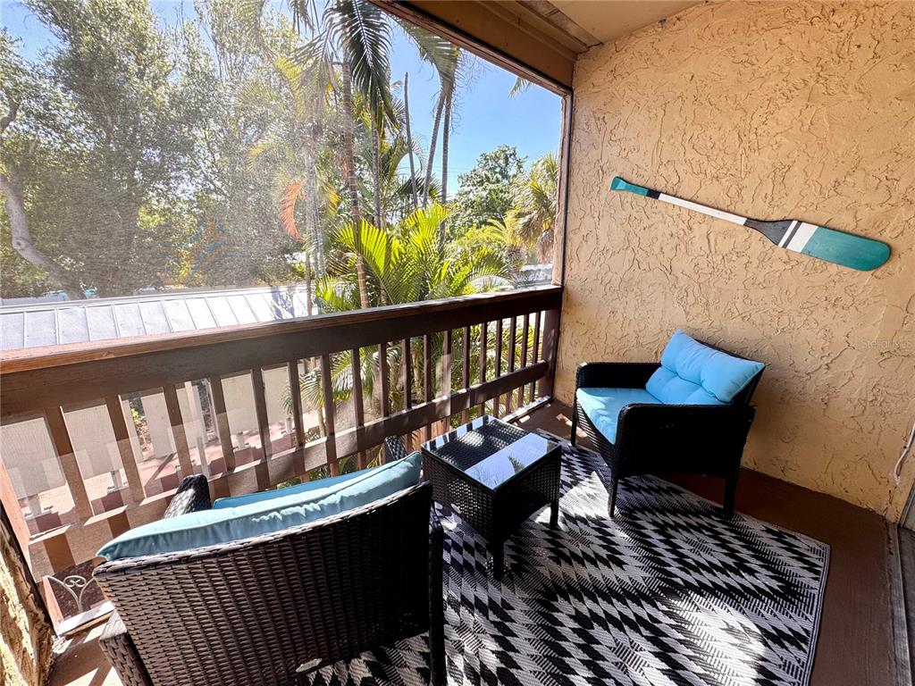 3443 Clark Road, Unit 242 Sarasota, FL 34231 - Photo 17 of 21 a roof deck with wooden floor and bench