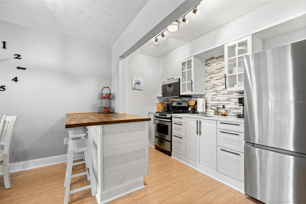3443 Clark Road, Unit 242 Sarasota, FL 34231 - Photo 6 of 21 a kitchen with granite countertop stainless steel appliances a sink and counter space