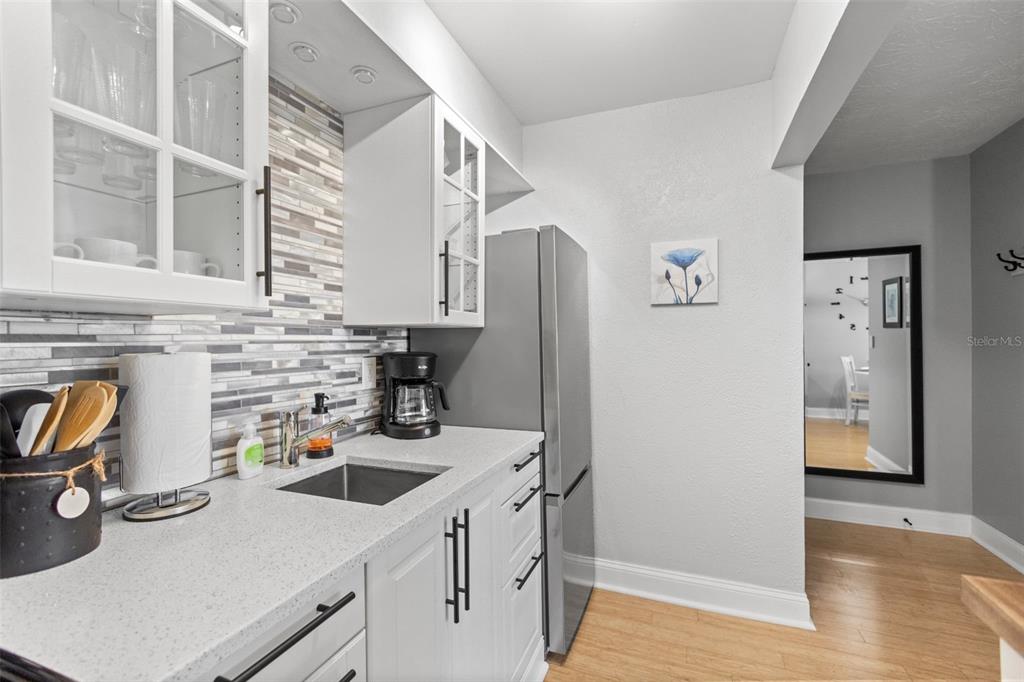 3443 Clark Road, Unit 242 Sarasota, FL 34231 - Photo 7 of 21 a kitchen with stainless steel appliances a sink a stove and a refrigerator