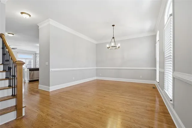 wooden floor in an empty room with a kitchen