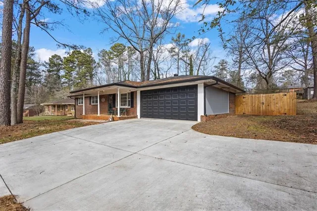 a front view of a house with a yard and trees