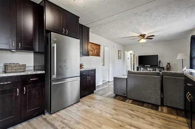 a living room with furniture a flat screen tv and a large window