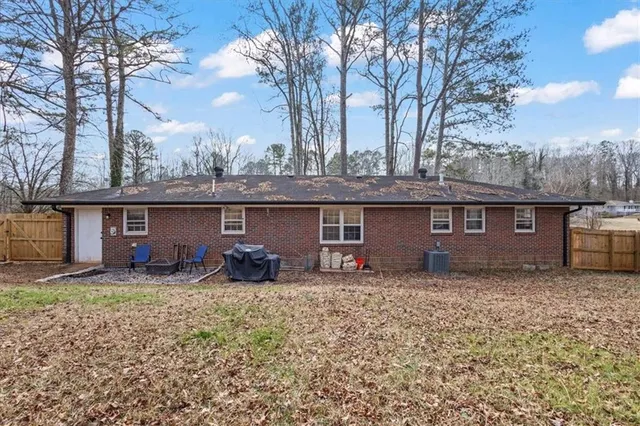 a view of backyard with wooden fence
