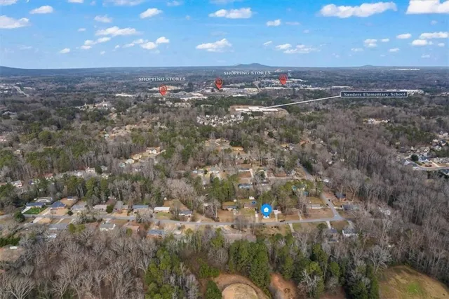 an aerial view of a house with a yard