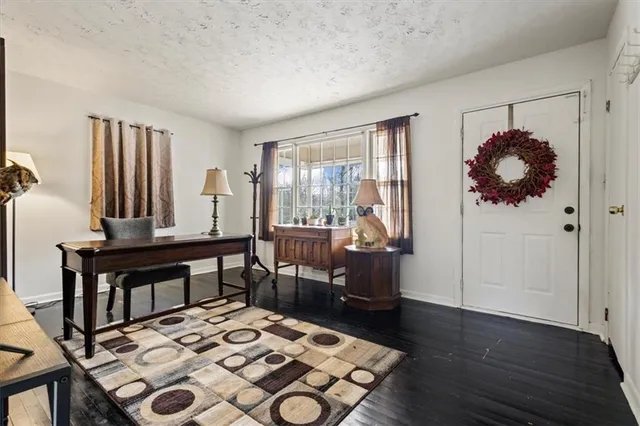 a room with furniture a rug and a window