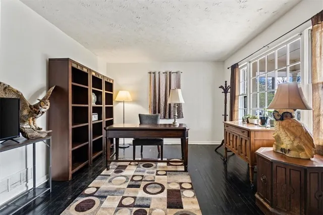 a living room with furniture a rug and a table