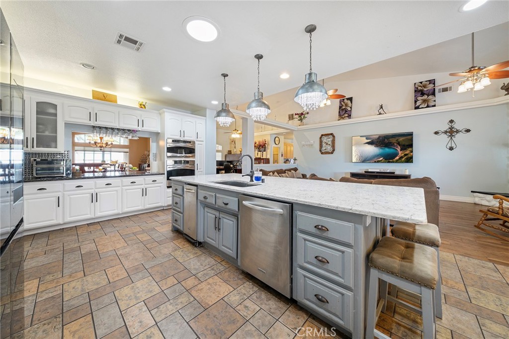 7172 Jargon Road Hesperia, CA 92344 - Photo 17 of 75 a large kitchen with kitchen island a large counter space a sink a stove and cabinets