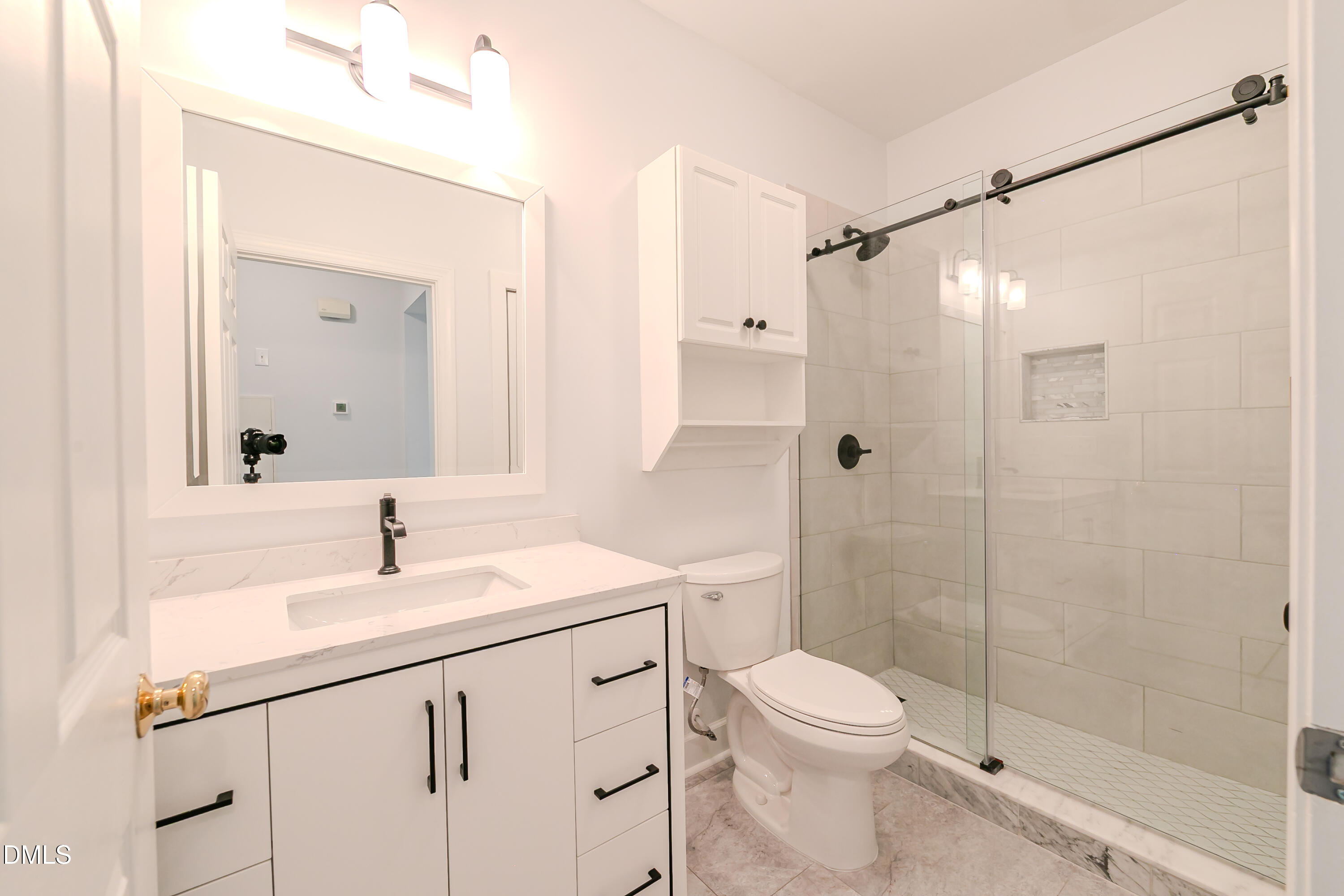 116 Northbrook Drive, Unit 305 Raleigh, NC 27609 - Photo 30 of 43 a bathroom with a sink a toilet and shower