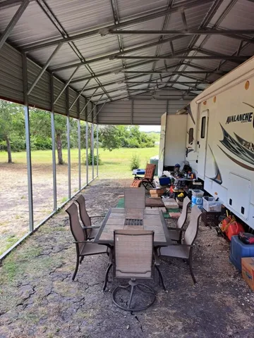 a view of a backyard with sitting area and furniture