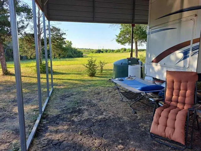 a view of a chairs and table in patio