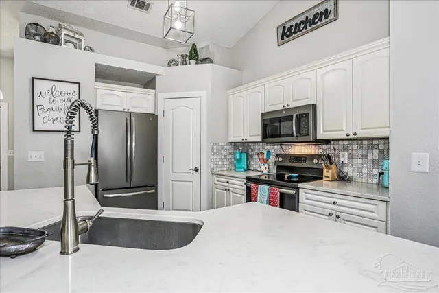 a view of a kitchen with a table and chairs