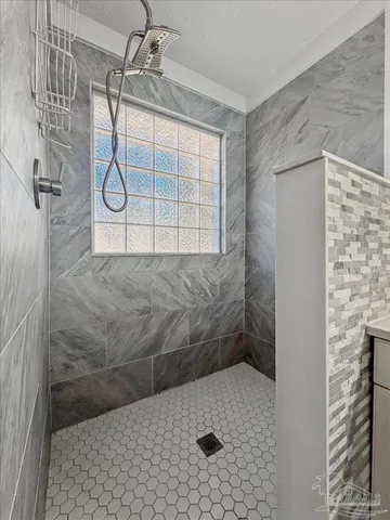 a bathroom with a sink a mirror and shower