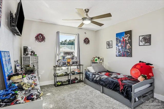 a bedroom with a bed and a painting on the wall