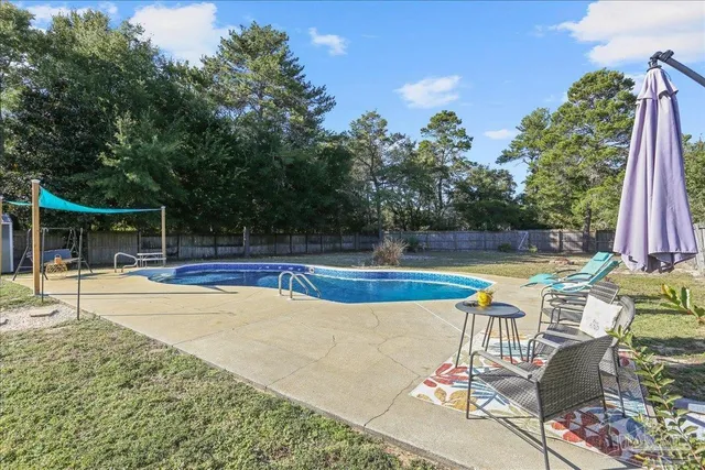 a view of a swimming pool with a yard