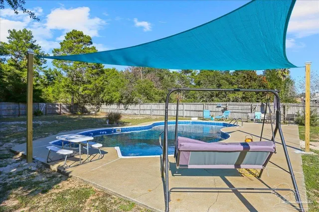 a view of a swimming pool with a lounge chair