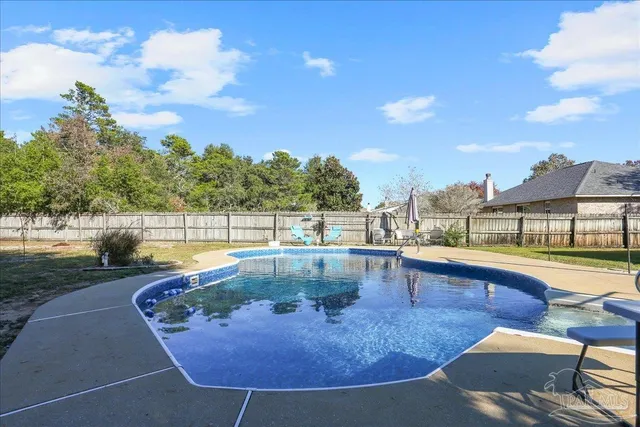 a view of a swimming pool with outdoor seating