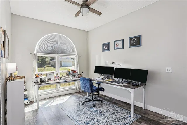a living room with furniture and a book shelf